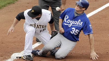 Andy LaRoche can't come up with the ball as the Royals' Mitch Maier slides safely into third base in the fifth inning.
