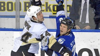 Brooks Orpik, left, slows down Tampa Bay's Martin St. Louis last night in Tampa, Fla.
