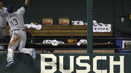 Rays outfielder Carl Crawford makes a catch on a ball hit by Rockies outfielder Brad Hawpe during seventh inning.