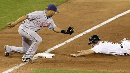 Pirates shortstop Jack Wilson steals third base in the ninth inning as Indians third baseman Jhonny Peralta attempts a tag.