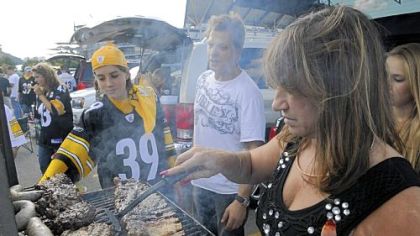 Ian Schantz, 15, of Pierpont, Ohio, watches his uncle and aunt, George and Sue Viglione of Monroeville, barbecue babyback ribs.