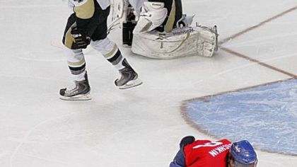 Capitals left winger Alex Ovechkin celebrates his second-period goal against Marc-Andre Fleury  and Rob Scuderi last night in Washington.
