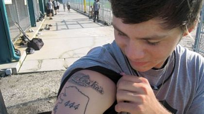 Pitcher Chris Aure, born in Alaska and a graduate of North Pole High School, shows off his tattoo.
