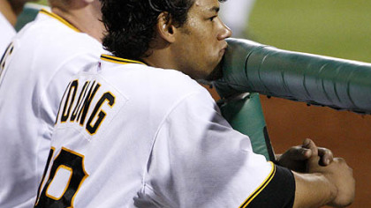 Pirates second baseman Delwyn Young stands in the dugout after striking out in the ninth inning.