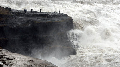 Tourists visit the Gullfoss waterfall in the canyon of the Hvita river in southwest Iceland.