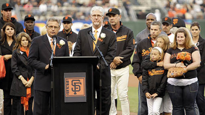 Giants announcers Mike Krukow, right of podium, and Duane Kuiper lead a pre-game tribute to Sue Burns, a part owner of the Giants who lost her battle with cancer.