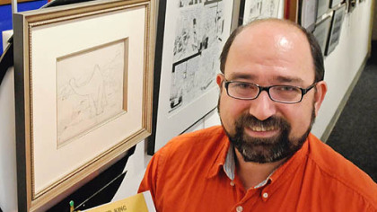 ToonSeum founder and director Joe Wos with a rare copy of The Montgomery Story comic.