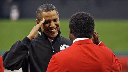 President Barack Obama salutes former cardinals outfielder Lou Brock before the first inning.
