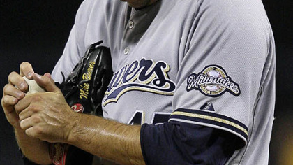 Brewers pitcher Mike Burns grips a ball on the mound after serving up a three-run home run to Pirates outfielder Delwyn Young.