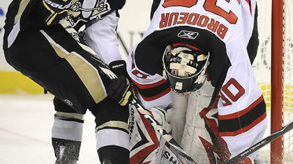 Chris Kunitz is stopped by the Devils goalie Martin Brodeur.