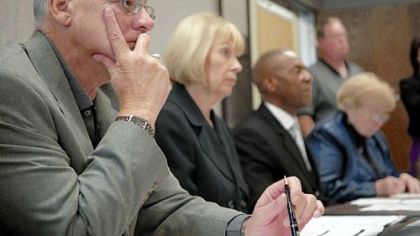 Intergovernmental Cooperation Authority board members listen to comments by Mayor Luke Ravenstahl yesterday. From left are  Richard Stanizzo, Barbara McNees, Curtis Aiken and Sister Grace Geibel.