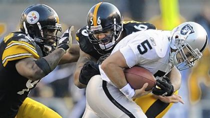 LaMarr Woodley sacks Raiders quarterback Bruce Gradkowski with help from James Harrison on Sunday. Statistically, the Steelers have a top 5 defense but a 6-6 record.