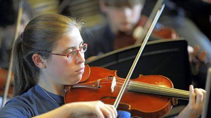 Violinist Lara Konefal-Shaer rehearses for a student production of "Les Miserables."