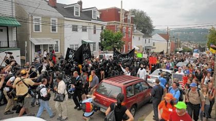 A group of anarchists lead an unlawful protest march that began at Arsenal Park in Lawrenceville and tried unsuccessfully to make its way to the David L. Lawrence Convention Center Downtown yesterday.