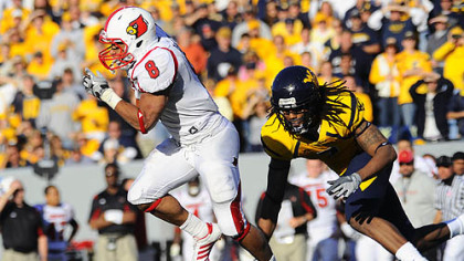 Louisville's Darius Ashley (8) carries the ball away from West Virginia's Brandon Hogan during the fourth quarter of yesterday's game in Morgantown.