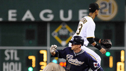 Padres third baseman Chase Headley slides into second base with a double as Pirates shortstop Ronny Cedano waits the throw in the ninth inning.