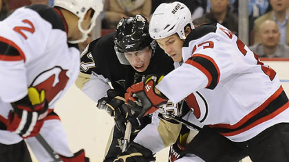 Sidney Crosby battles for loose puck with the Devils David Clarkson in the third period.