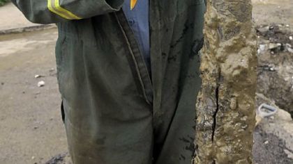 C.D. Smith shows a break in a lead, 100-year-old 1-inch supply line that was repaired along Penn Avenue in the Strip District.