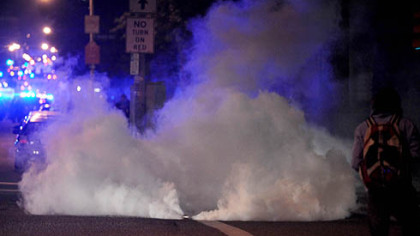 Riot police lob gas grenades Friday night following a student protest near Schenley Plaza.
