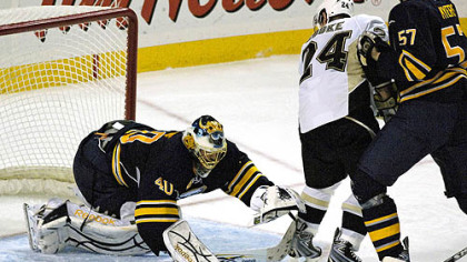 Patrick Lalime, on in relief of Ryan Miller, reaches to cover a loose puck as Sabres defenseman Tyler Myers checks Matt Cooke during the third period.