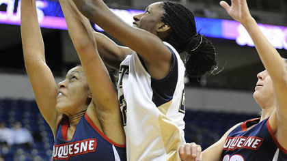 Duquesne player Samantha Pollino (30) battles for a rebound against Pitt's Chelsea Cole (22).