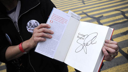 Leann Marcolini, of Frederickstown, shows off her signed copy of "Going Rogue: An American Life" by author Sarah Palin.
