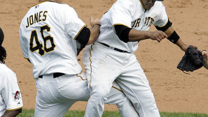 Pirates first baseman/outfielder Garrett Jones and second baseman Delwyn Young celebrate yesterday's win.