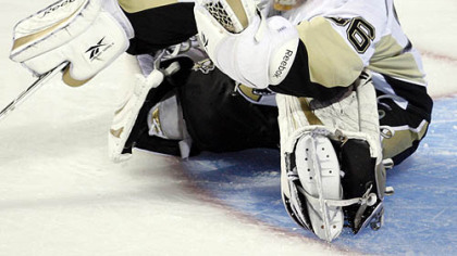 Penguins goaltender John Curry makes a glove save against the Canadiens during second period of las night's 4-3 loss in Montreal.