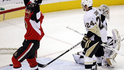 Senators forward Nick Foligno celebrates a goal by teammate Matt Carkner, not shown, on Penguins goaltender Marc-Andre Fleury and forward Matt Cooke during the first period of tonight's game at Scotiabank Place in Ottawa.
