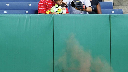 Lastings Milledge falls onto his back after making a sliding catch into the left-field wall for the final out of the sixth inning. After being down for several minutes, Milledge walked off the field and remained in the game.