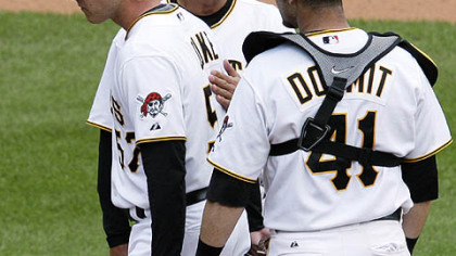 Pirates pitcher Zach Duke, left, is pulled from the game in the ninth inning with two outs, and with a 10-run lead by manager John Russell, center, as catcher Ryan Doumit watches during yesterday's 11-1 win at PNC Park.