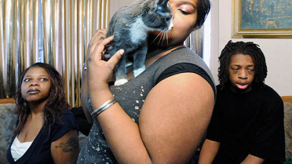 Brittany Boyer, 16, nuzzles her kitten, Silver, after school with her mother, Darlenea Adetona, left, and brother, Michael "M.J." Adetona, 15. Mrs. Adetona and her three children (daughter Ashley Boyer, 18, is not pictured) recently moved in with a relative.