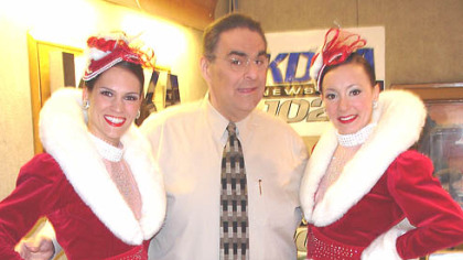 Fred Honsberger poses with the Rockettes.