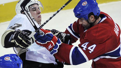 Canadiens defenseman Roman Hamrlik gets his stick up on Penguins forward Sidney Crosby during the second period.