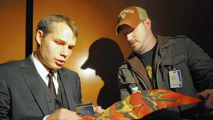Shepard Fairey autographs his book on Oct. 17 after speaking to sold-out crowed before the opening of his show "Shepard Fairey: Supply and Demand" at The Andy Warhol.
