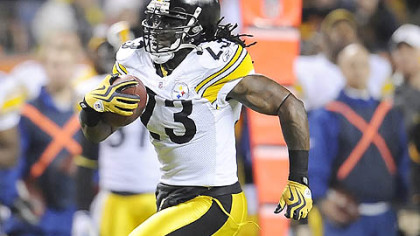 Steelers safety Tyrone Carter runs back an  interception for a touchdown during the first half of a 28-10 win against the Broncos at Invesco Field in Denver last night.