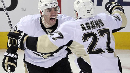 Penguins forward Pascal Dupuis celebrates with teammate Craig Adams after scoring the go-ahead goal against the Canadiens during the third period of a 3-2 win at the Bell Centre in Montreal last night.