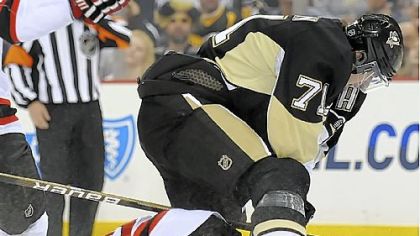 Evgeni Malkin leaps over Devils goalie Martin Brodeur during Saturday night's loss at Mellon Arena.