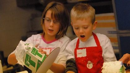 Maranda Scherer, 9, of West Mifflin, and Drake Lemasters, 5, of Lincoln Place, take part in the gingerbread house class at Rania's Catering in Mt. Lebanon. Increasing numbers of boys are interested in cooking and baking.