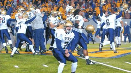 Pitt's Steve Malinchak (7) and teammates celebrate their 13-9 upset win over No.2 West Virginia Dec. 1, 2007 in Morgantown, W.Va. In one night, a Pitt program that had trailed its neighbor for years caught up. Now, the Panthers are in the top 10 and looking for a big bowl, and West Virginia is trying to play the spoiler.
