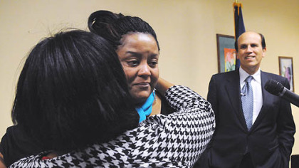 Jamilla Rice tears up as  her mother, Dr. Aisha White, embraces her. Michael Milken is at right.