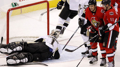 Senators forward Jonathan Cheechoo, No. 41, celebrates his goal with team captain Daniel Alfredsson as Penguins goaltender Brent Johnson looks back at the net during the third period.