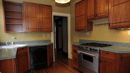 The new kitchen, which overlooks a large outdoor patio, features an island with additional seating and a lounge area with television and stereo.