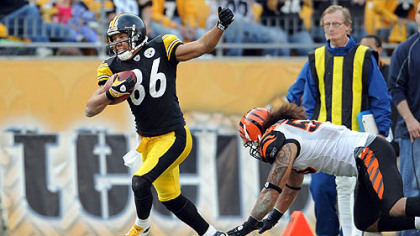 Steelers wide receiver Hines Ward steps along the sideline as he's defended by Bengals linebacker Rey Maualuga in the fourth quarter.