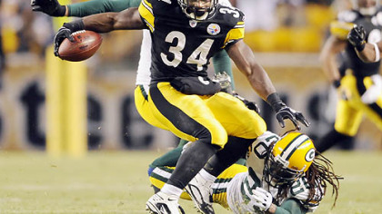 Rashard Mendenhall tries to spin out of a tackle by Green Bay's Atari Bigby in last Sunday's game. Mendenhall needs only 22 yards against the Ravens to become the seventh Steelers runner to turn in a 1,000-yard season.