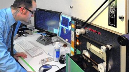 In a control room filled with vintage video equipment, Media Preserve video technician Chris Shevlin plays old 16mm black-and-white WQED-TV news footage into a Macintosh computer during the restoration and digitizing process. The company is recovering and restoring a variety of old film, kinescopes and tape for WQED-TV. The company rebuilds and uses equipment long ago consigned to storage or junk as it's the only way to play back old media. The restored images are digitized for current use.