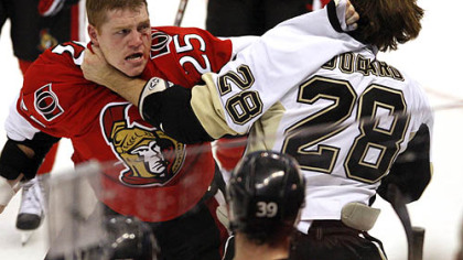 Senators forward Chris Neil fights with Penguins forward Eric Goddard during the third period of last night's game in Scotiabank Place in Ottawa.