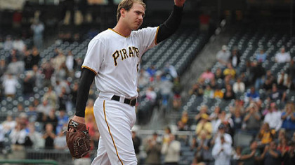 Pirates pitcher Zach Duke raises his hat for cheering fans as he leaves the game.