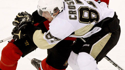 Senators defenseman Chris Phillips checks Penguins forward Sidney Crosby during the second period.