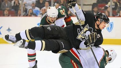 Sidney Crosby goes airborne as Minnesota's Greg Zanon ducks under him in the game last night at Mellon Arena -- a rare Penguins loss despite the fact that they gave up just 13 shots to the Wild.